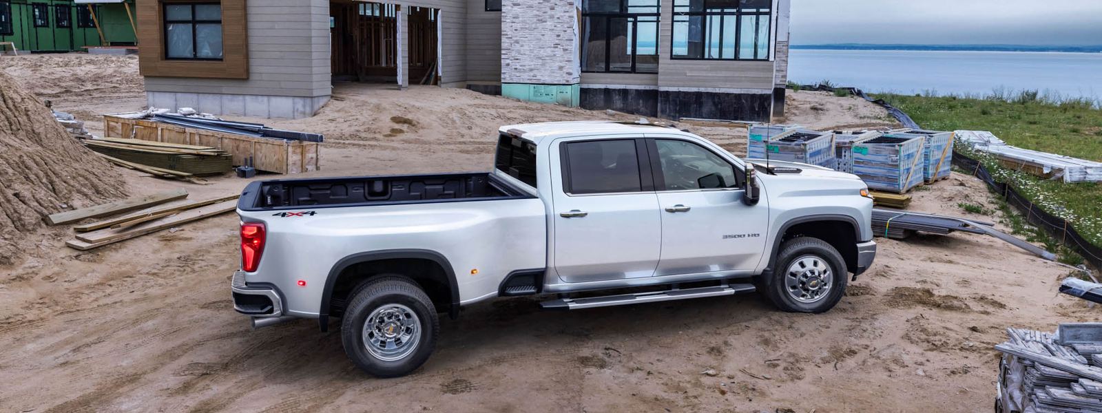 Chevrolet Silverado 2500HD work truck parked at a residential construction site